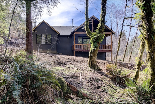 rear view of house featuring a deck