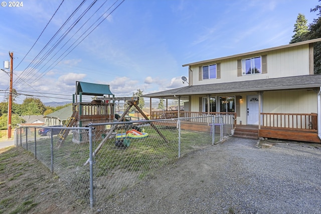 view of front of house with a playground and covered porch