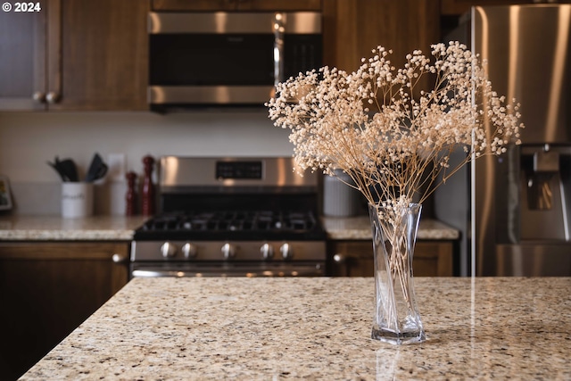 kitchen featuring light stone countertops and appliances with stainless steel finishes