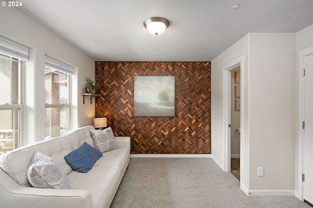 living area featuring light carpet and a textured ceiling