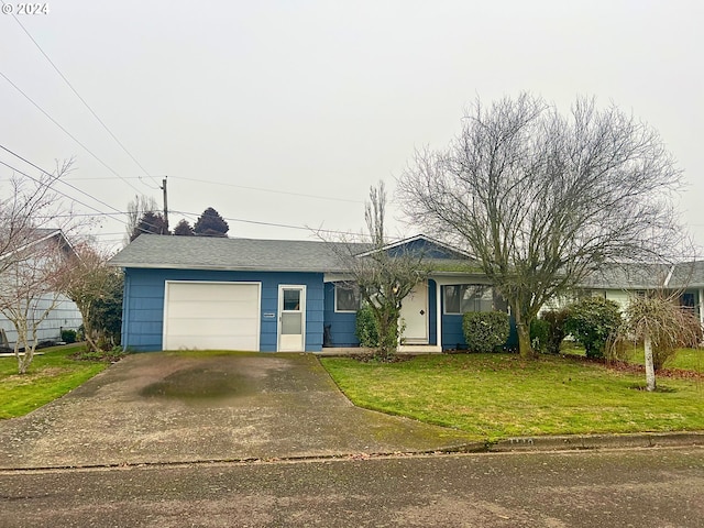 single story home with a garage and a front lawn