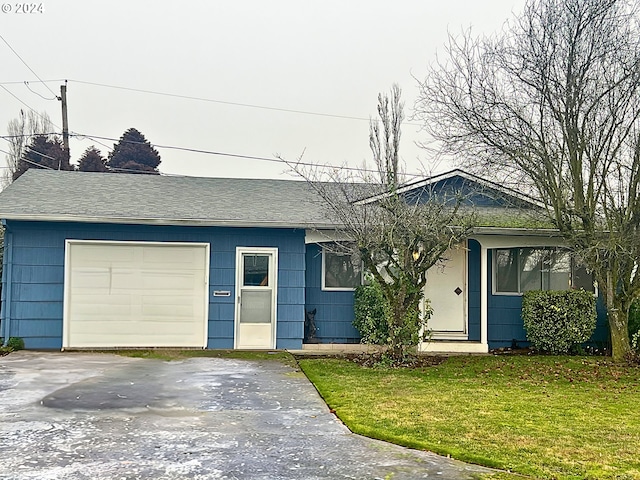 single story home with a garage and a front lawn