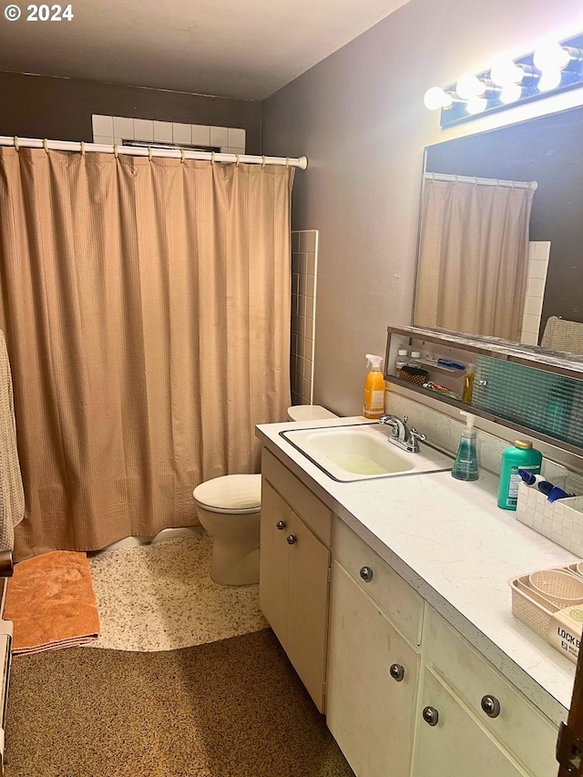 bathroom with vanity, toilet, and walk in shower