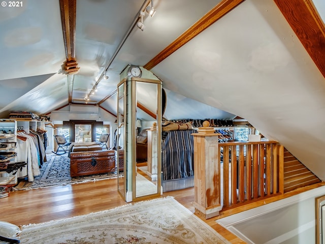 additional living space featuring lofted ceiling and light hardwood / wood-style flooring