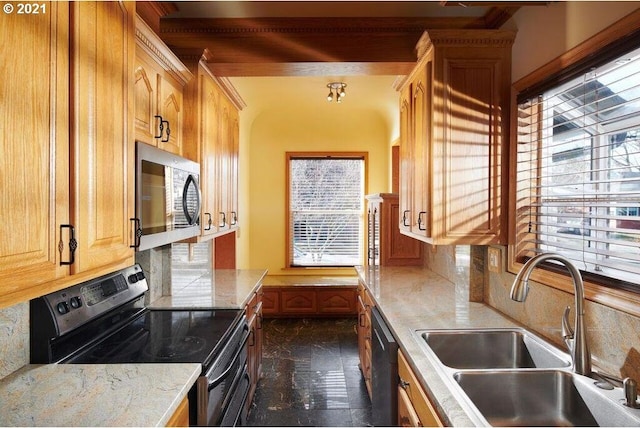 kitchen featuring black appliances, decorative backsplash, and sink