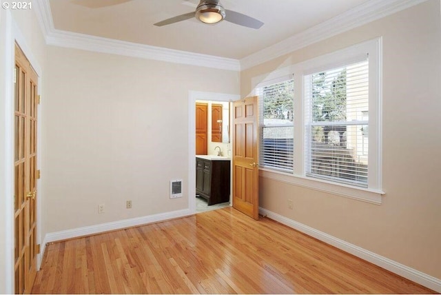 unfurnished bedroom with ceiling fan, light hardwood / wood-style floors, ornamental molding, and sink