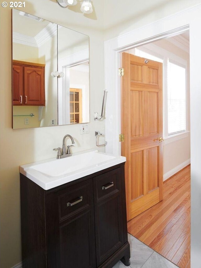 bathroom featuring vanity, tile patterned floors, and ornamental molding