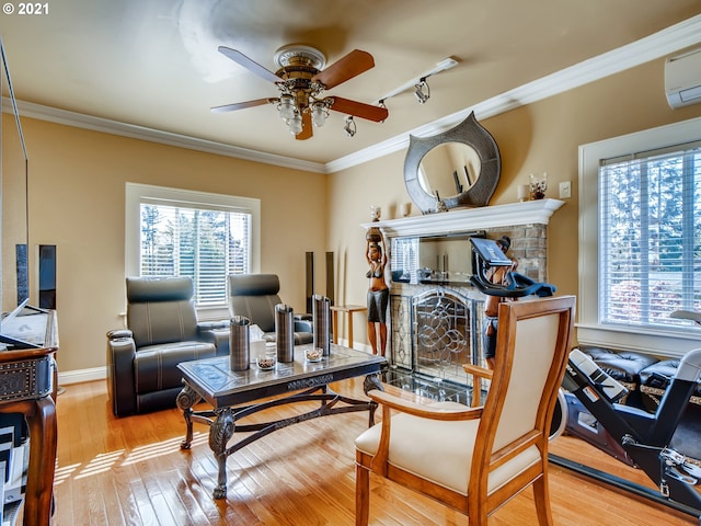 living area with crown molding and a wealth of natural light