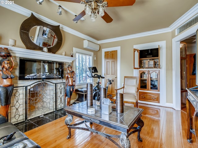 living room featuring an AC wall unit, crown molding, ceiling fan, and wood-type flooring