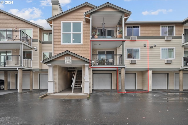 exterior space featuring a balcony and a garage