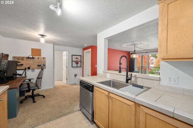 kitchen with light brown cabinetry, a textured ceiling, sink, and dishwasher