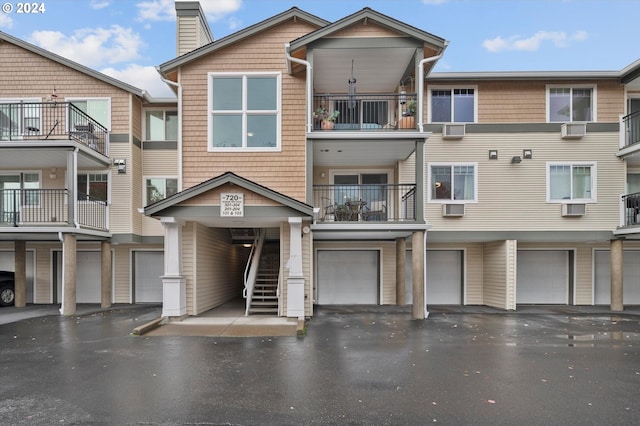 exterior space with a garage and a balcony