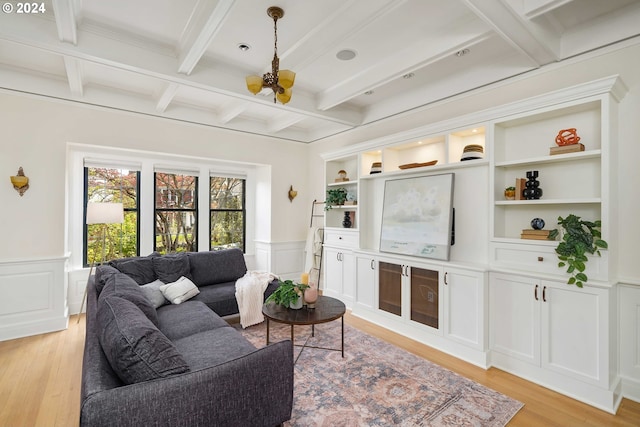 living room with beamed ceiling and light hardwood / wood-style floors