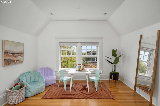 living room featuring vaulted ceiling and light wood-type flooring