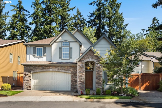 view of front facade with concrete driveway, roof with shingles, an attached garage, fence, and stucco siding