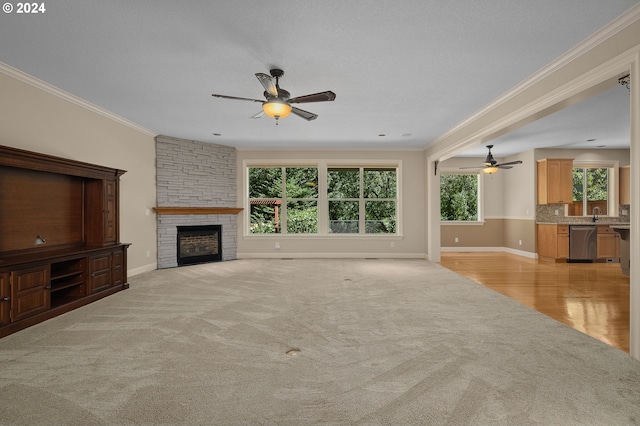 unfurnished living room featuring plenty of natural light, ornamental molding, and a fireplace