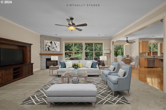 living room featuring a large fireplace, baseboards, a ceiling fan, and crown molding