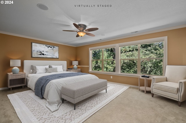 bedroom with ceiling fan, crown molding, light carpet, and a textured ceiling