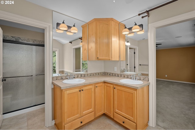 kitchen featuring sink, vaulted ceiling, light colored carpet, and light brown cabinetry