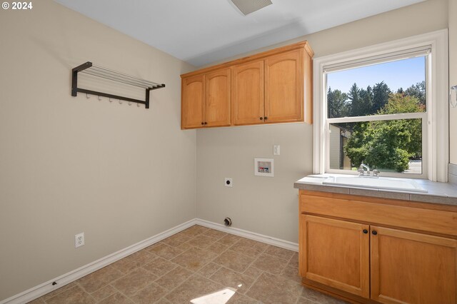 laundry room featuring washer hookup, cabinets, sink, and hookup for an electric dryer