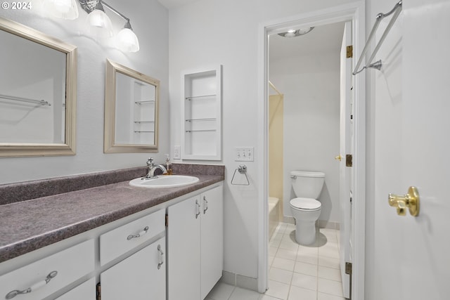 full bathroom featuring toilet, vanity, tile patterned flooring, and shower / washtub combination