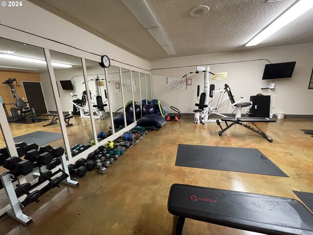 workout area featuring a textured ceiling