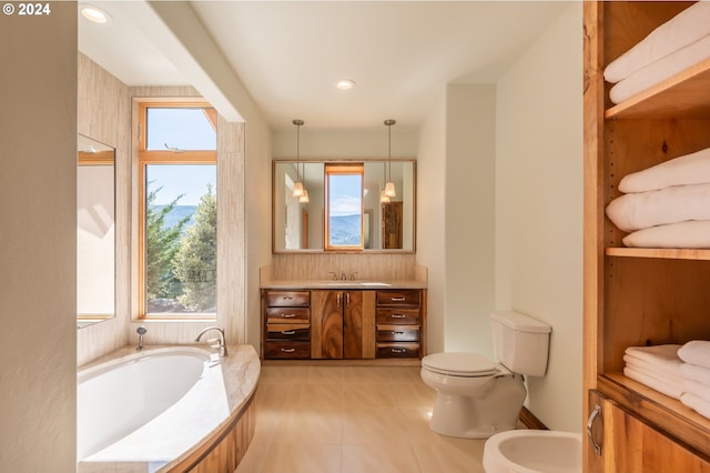 bathroom with toilet, oversized vanity, a bidet, tile flooring, and a tub