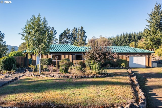 view of front facade with a front lawn and a garage