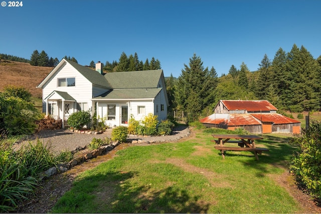 view of side of property with a yard