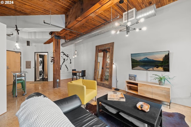 living room with a towering ceiling, stacked washer and clothes dryer, and wood ceiling