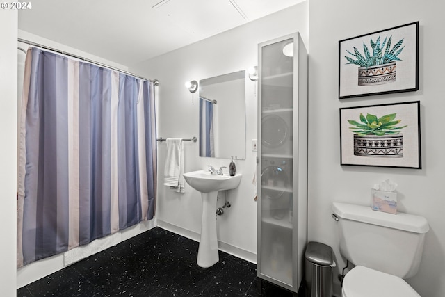 bathroom featuring curtained shower and toilet