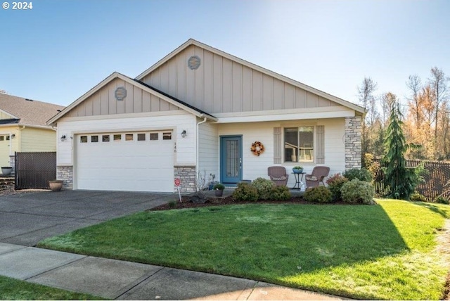 view of front facade featuring stone siding, board and batten siding, and driveway