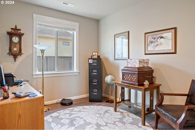 home office with wood finished floors and baseboards