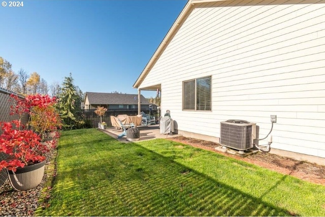 view of yard with central air condition unit and a patio area