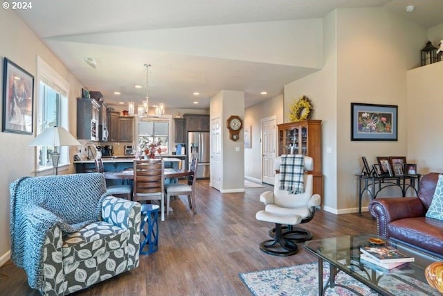 living room featuring a chandelier, dark wood-style floors, baseboards, recessed lighting, and high vaulted ceiling