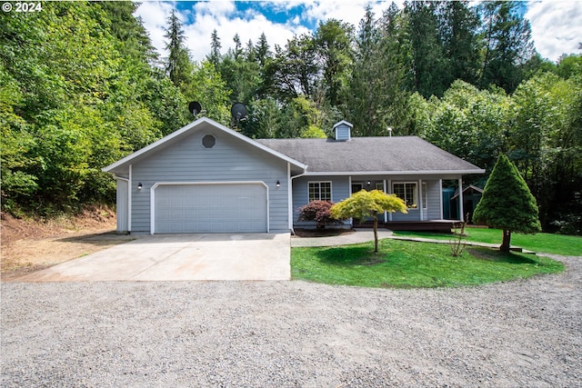 ranch-style home featuring a porch, a garage, and a front lawn