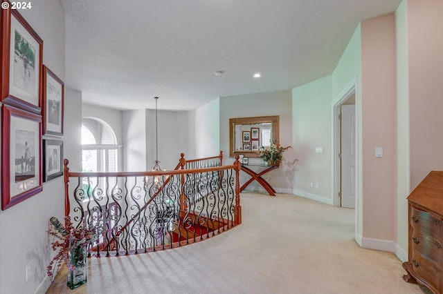 hallway with light colored carpet