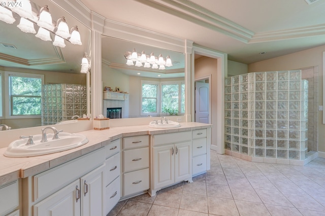 bathroom with a raised ceiling, crown molding, plenty of natural light, and vanity