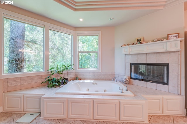 bathroom featuring a washtub, tile patterned flooring, and a tiled fireplace