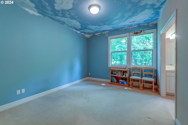 carpeted spare room with a textured ceiling