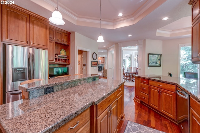 kitchen featuring a center island, crown molding, appliances with stainless steel finishes, and a tray ceiling