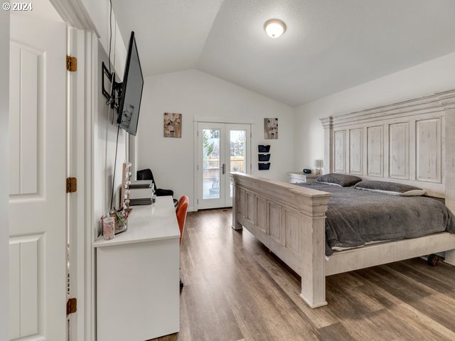 566 N 11th St, Aumsville, OR 97325 - bedroom with lofted ceiling, french doors, access to outside, and wood finished floors