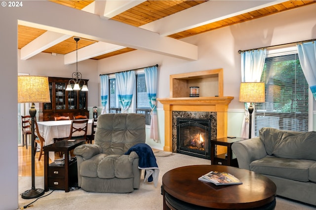 carpeted living room with a fireplace, beam ceiling, and wooden ceiling