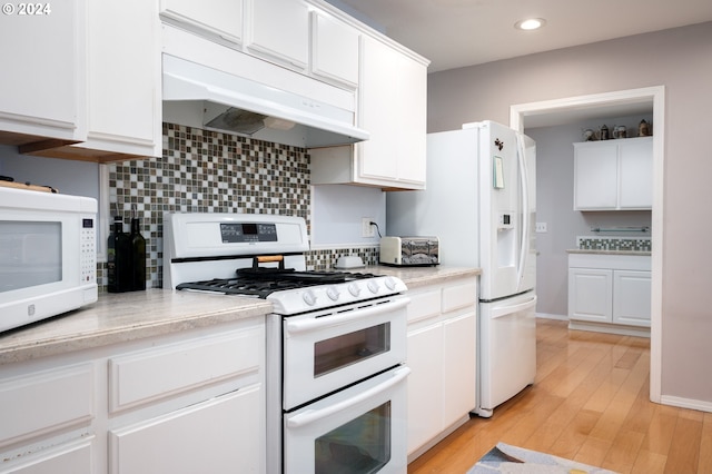 kitchen featuring backsplash, white appliances, light hardwood / wood-style floors, and white cabinets