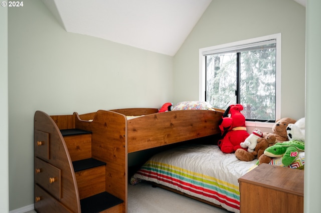 bedroom featuring lofted ceiling and carpet