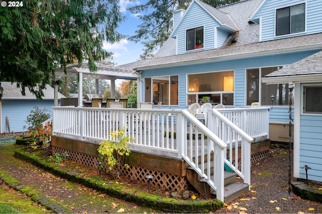 back of house with a wooden deck and a pergola