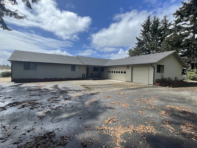 ranch-style house with an attached garage and driveway