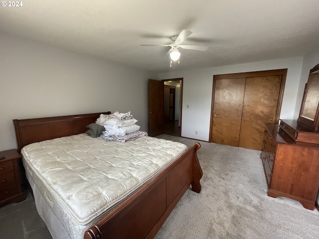 carpeted bedroom featuring a ceiling fan and a closet