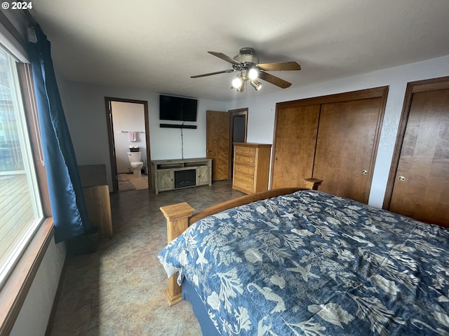 bedroom with a ceiling fan and multiple closets