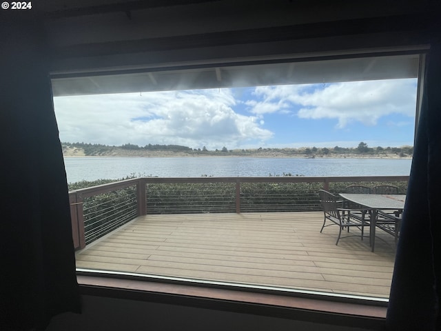 wooden deck featuring a water view